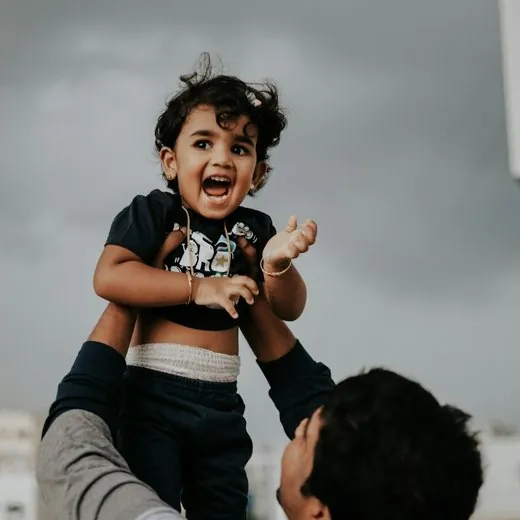 A father lifting his child into the air